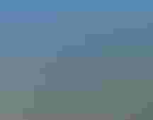 A group of people stand in a prairie