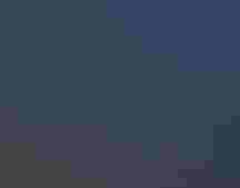 People on a boardwalk at night with moonrise