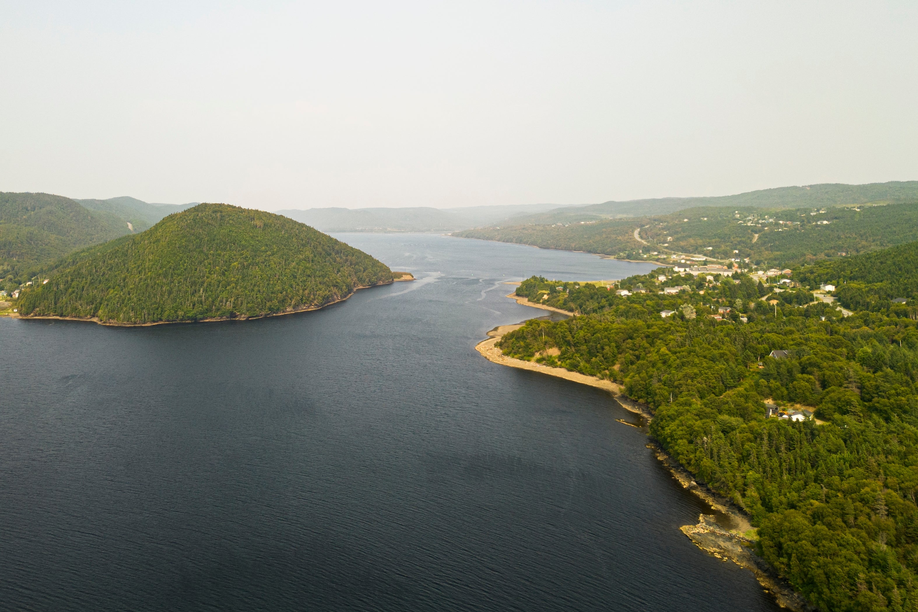 Aerial view of green land and blue water
