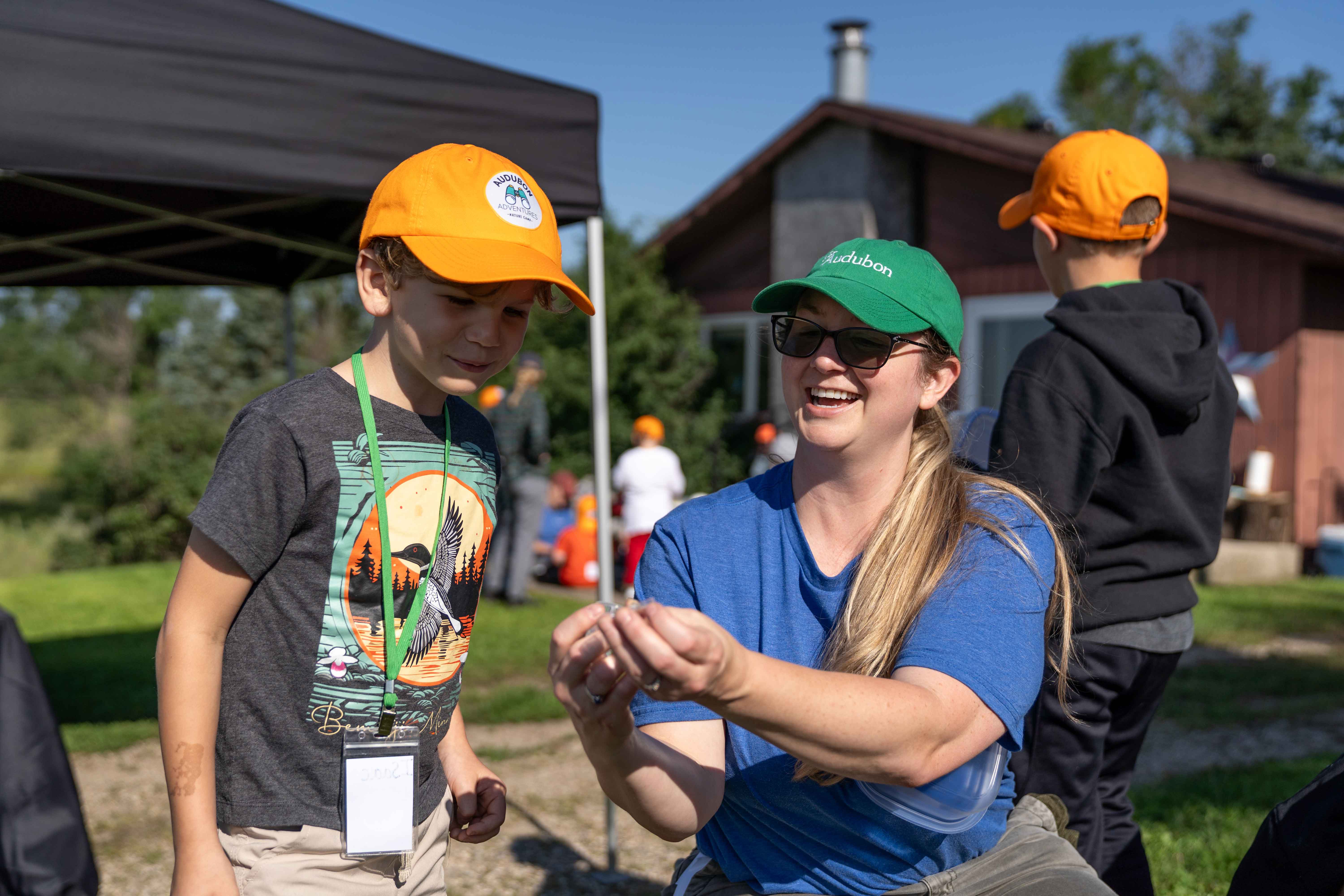 Young child looking at nature item