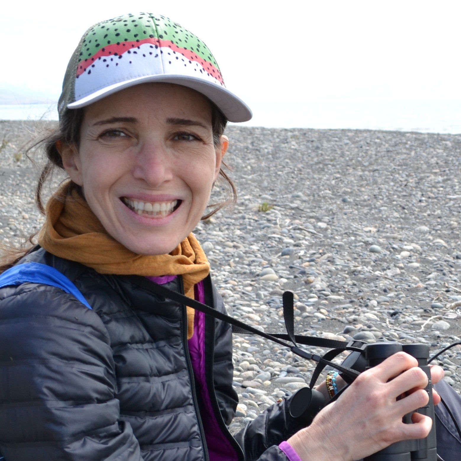 Woman smiling holding binoculars