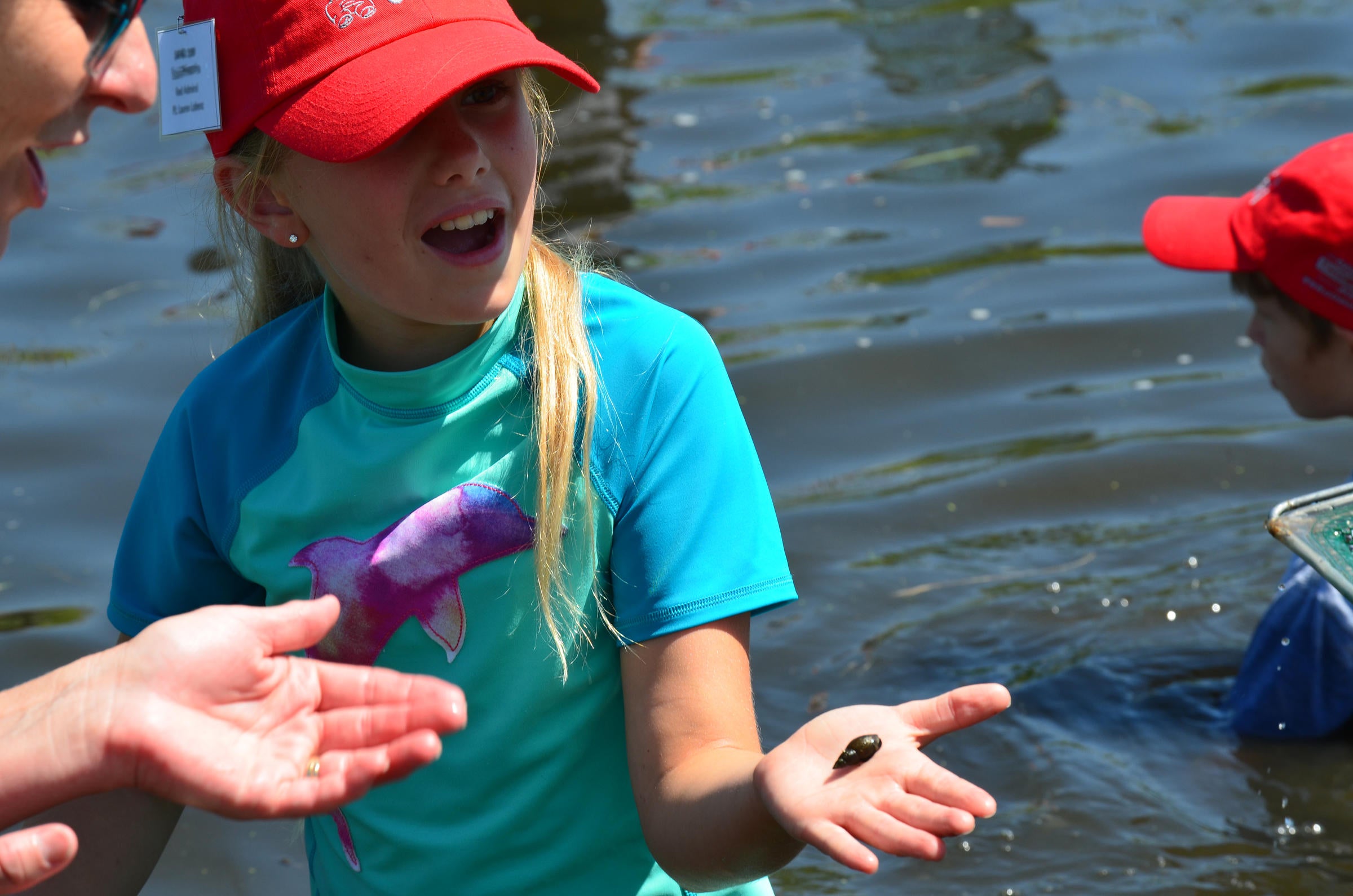 Young girl in the river with a leech.