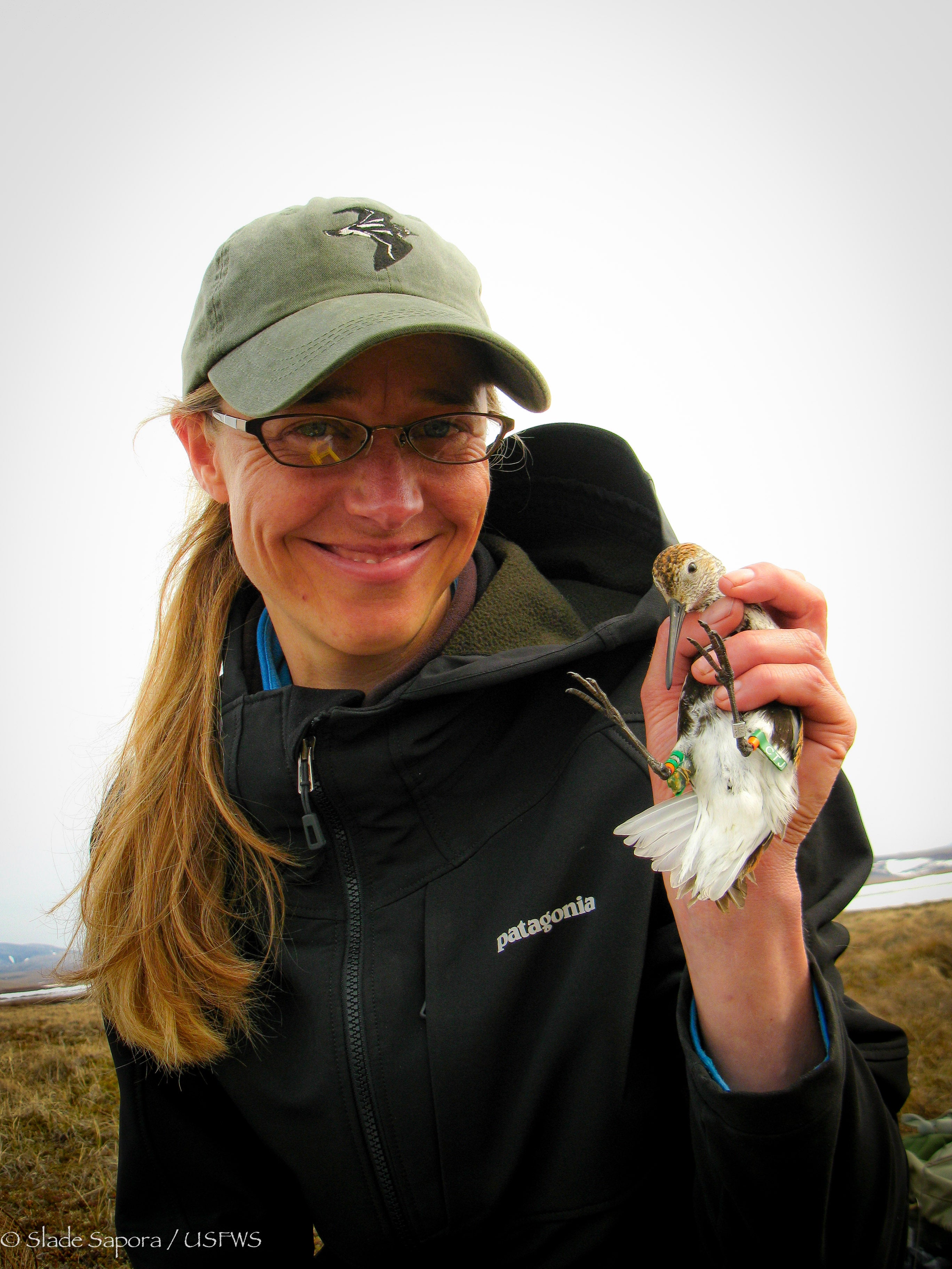 Woman smiling holding bird