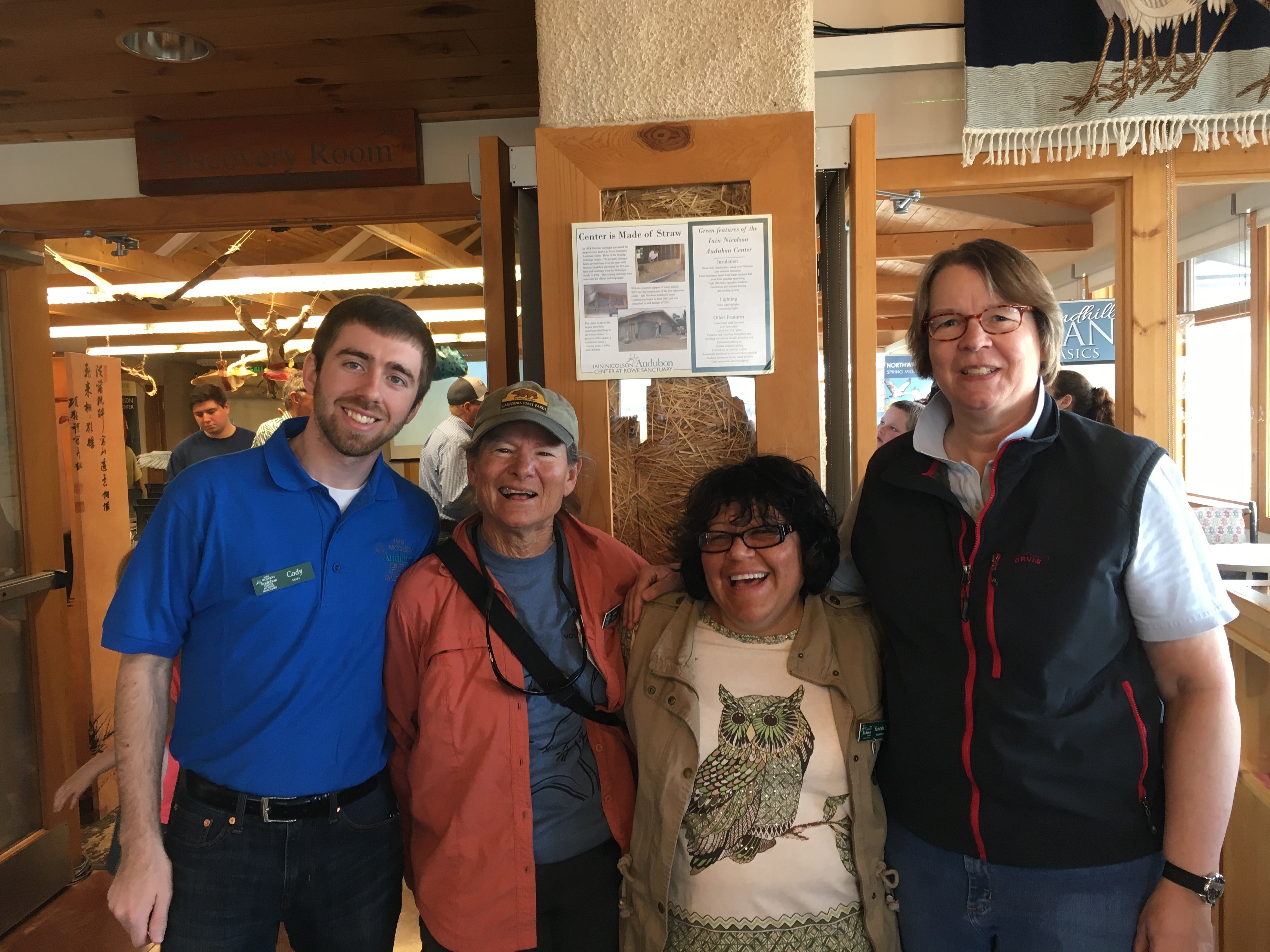 four people standing together