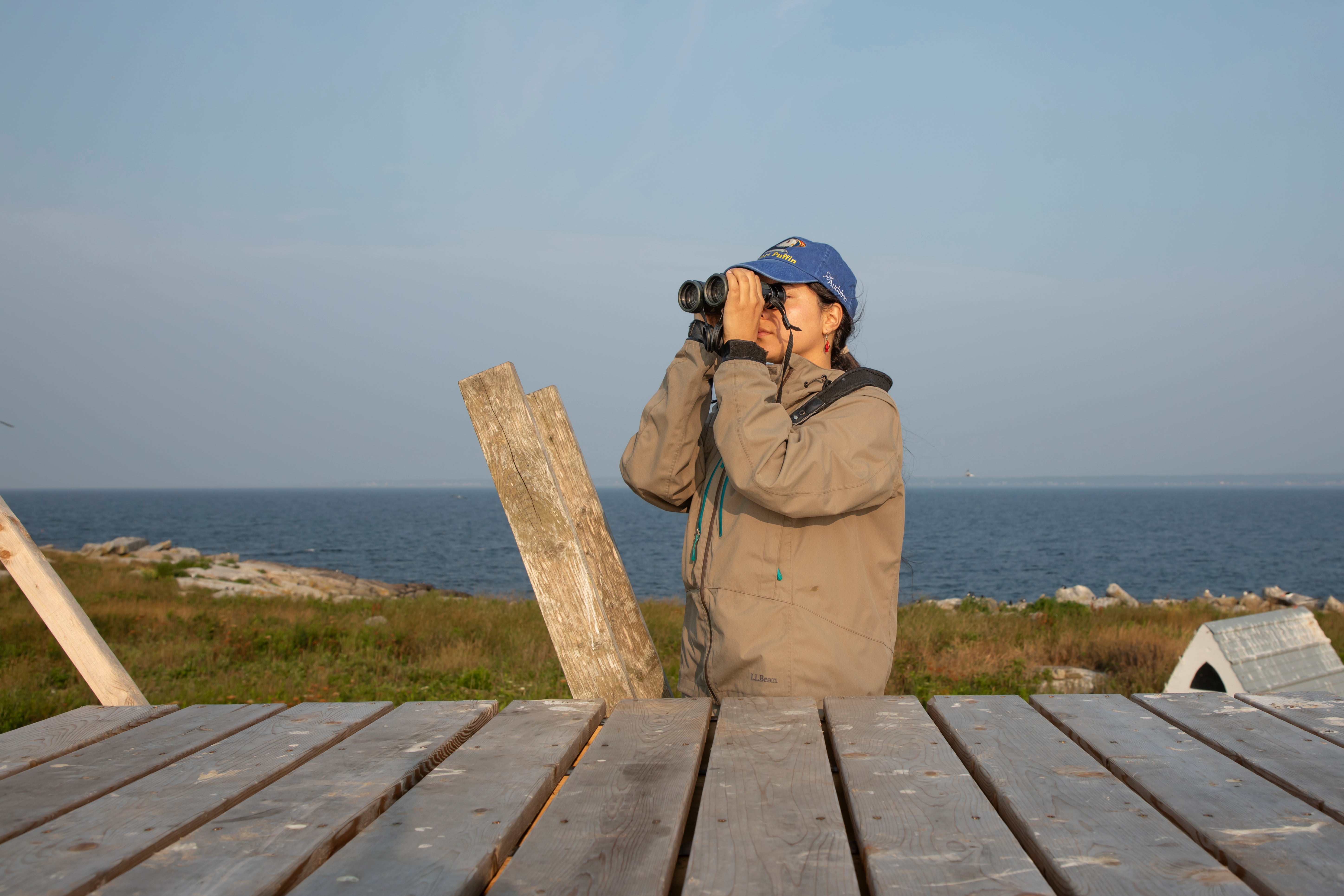 An international researcher looking through binoculars