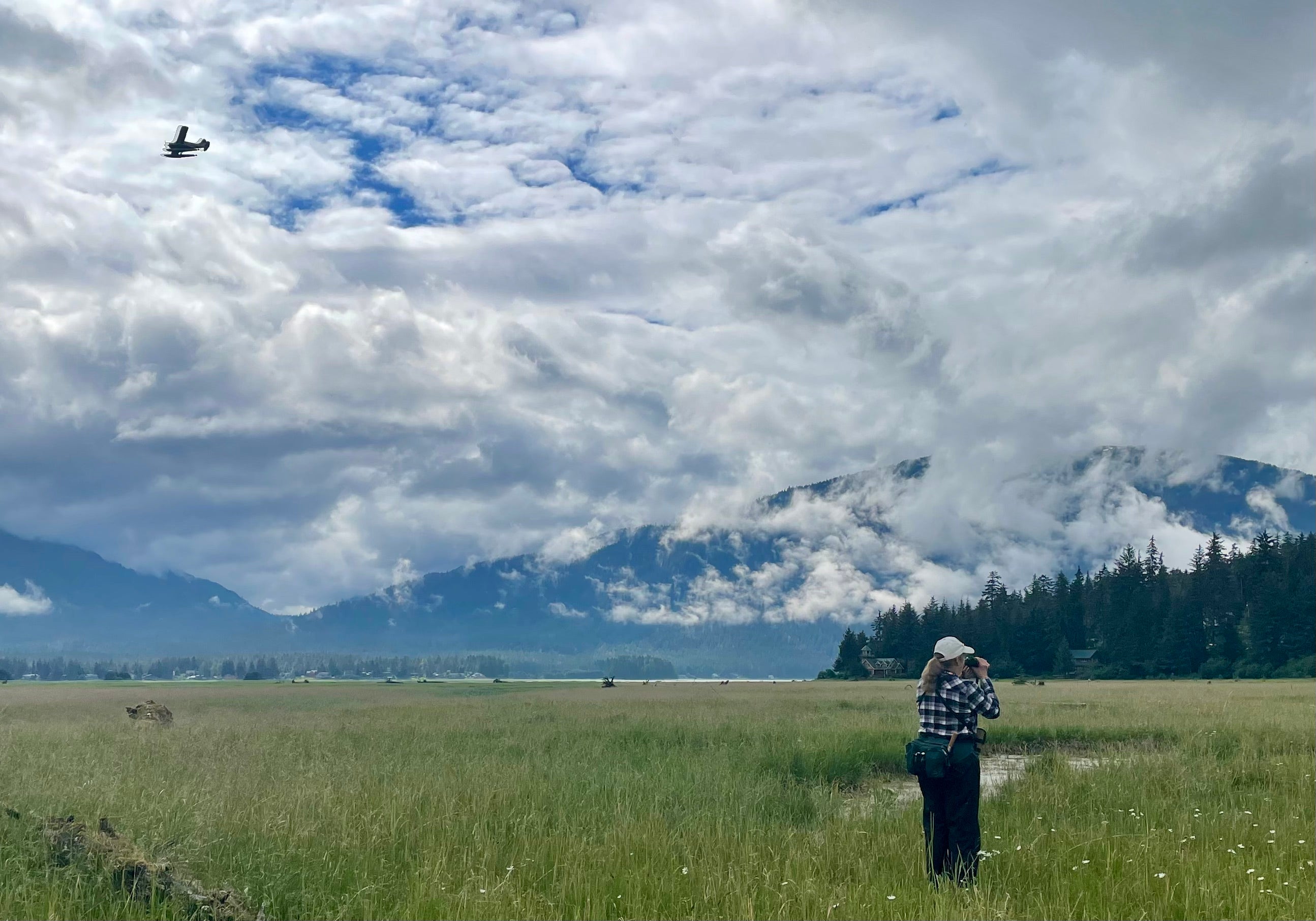 Woman on wetlands with binoculars