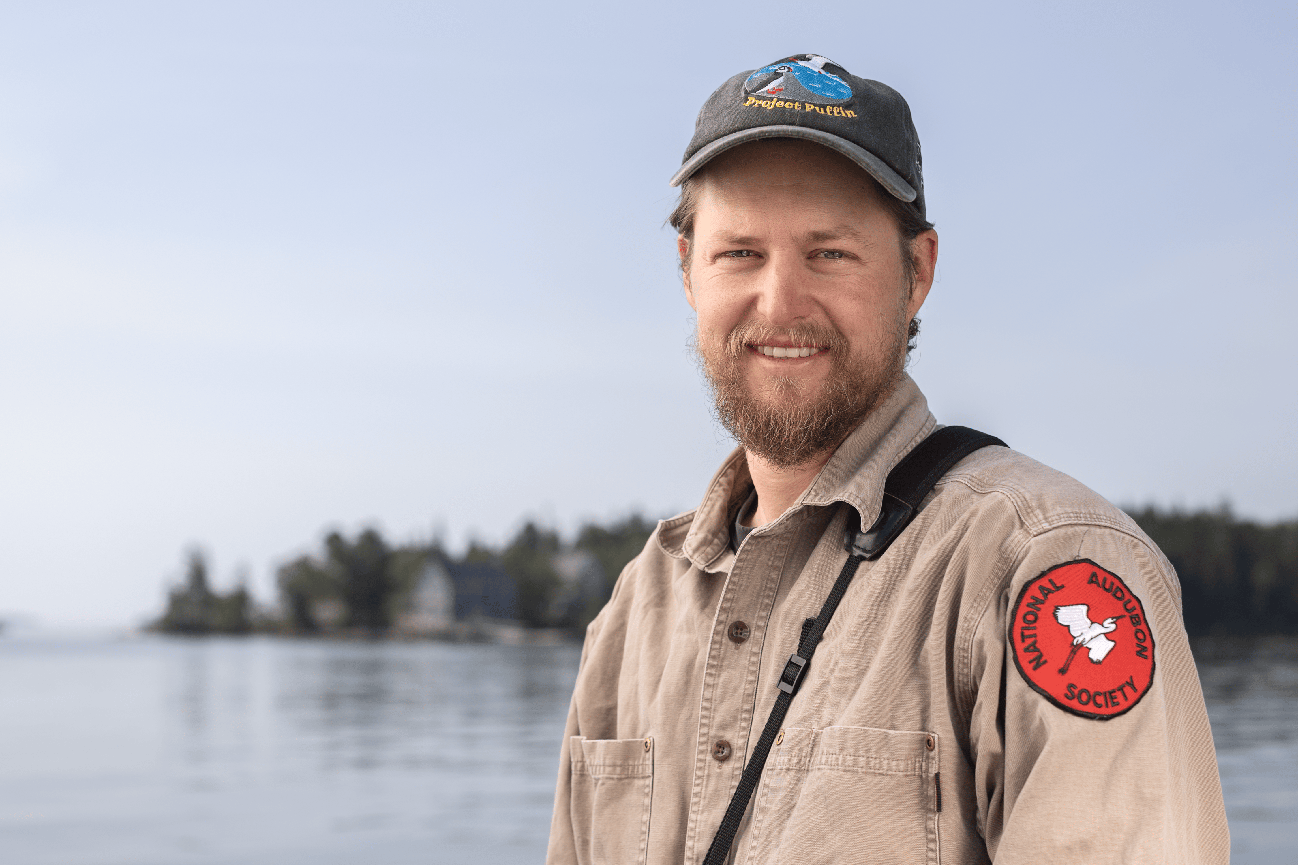 A person standing with Hog Island in the background.