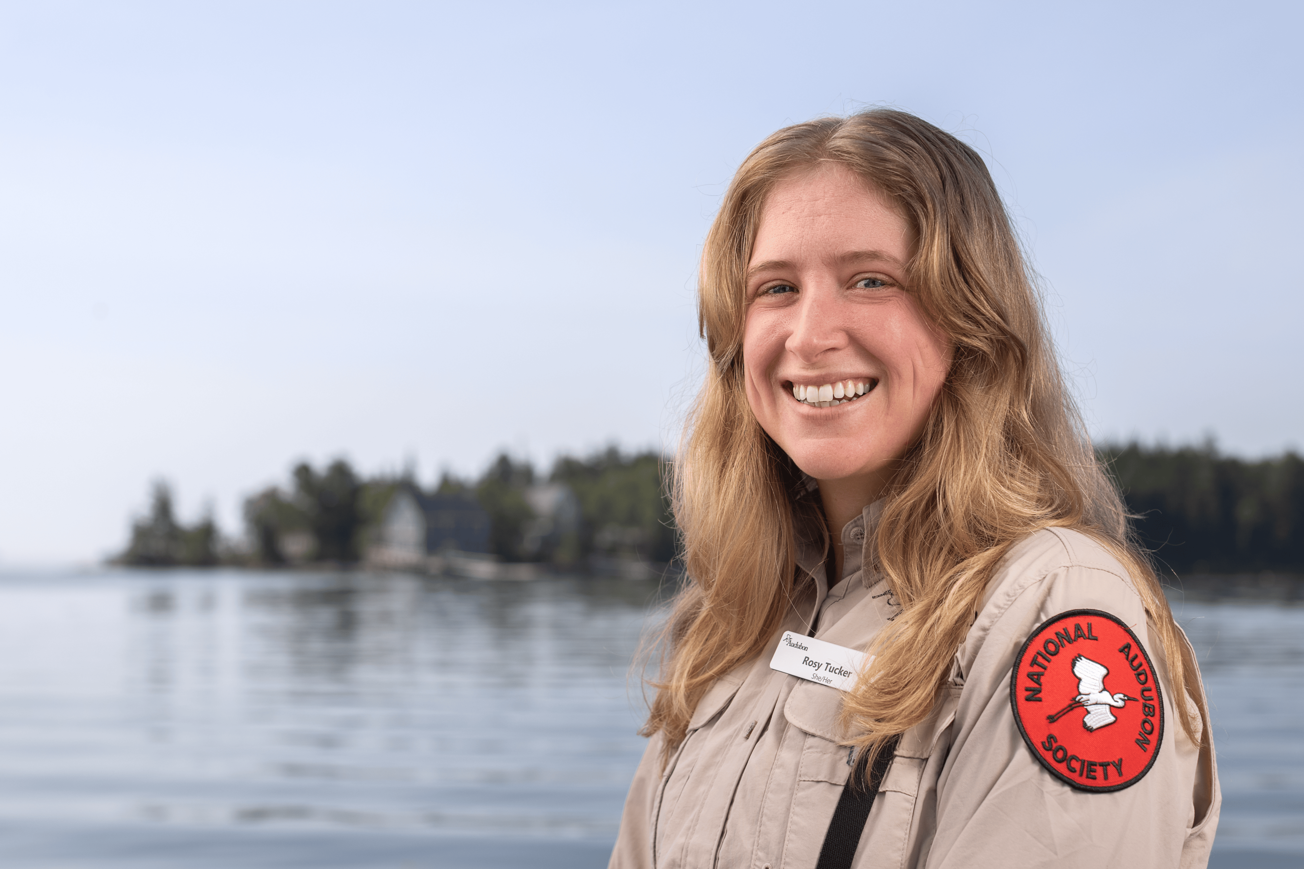 A person standing with Hog Island in the background.