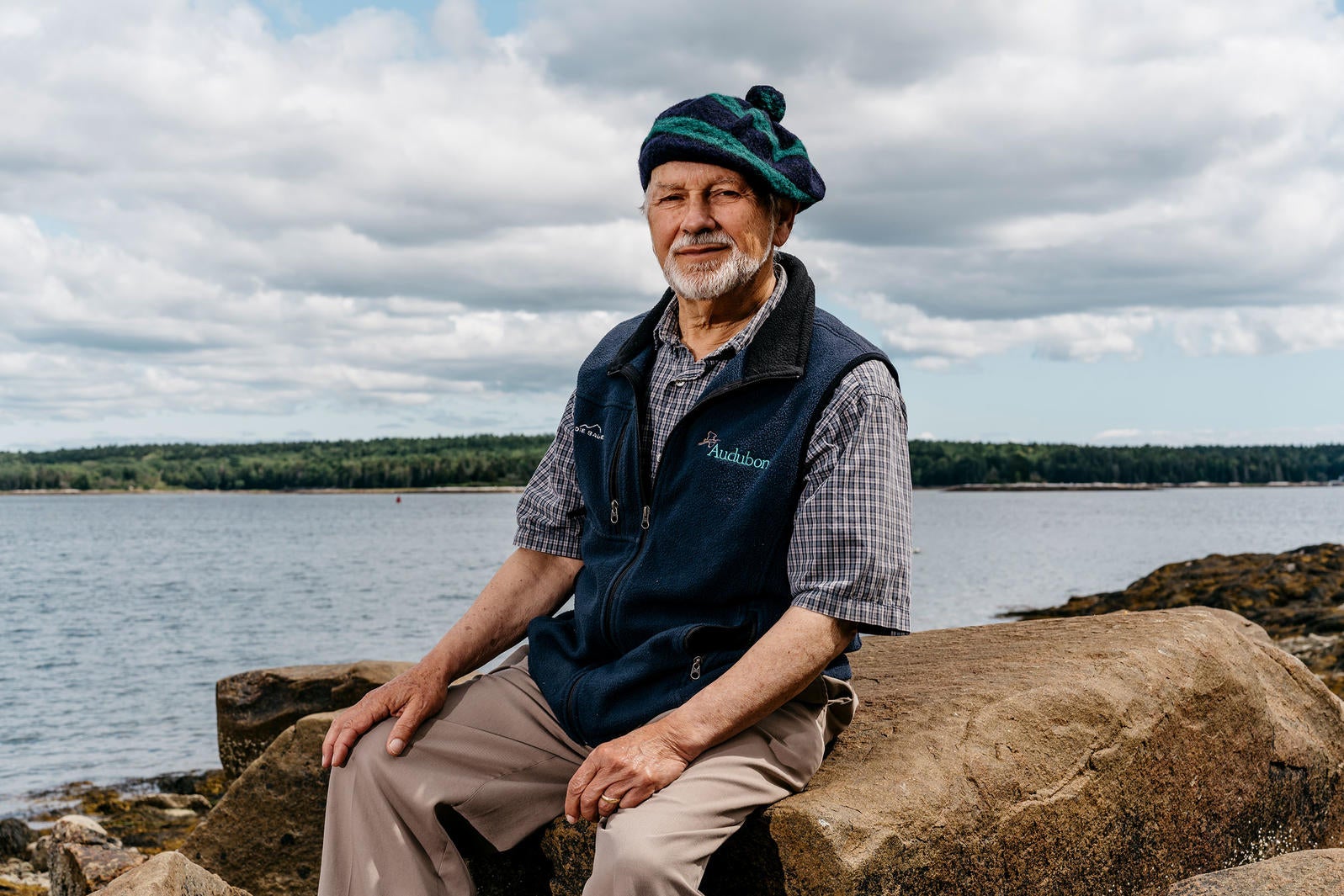 A person sitting on a rock.