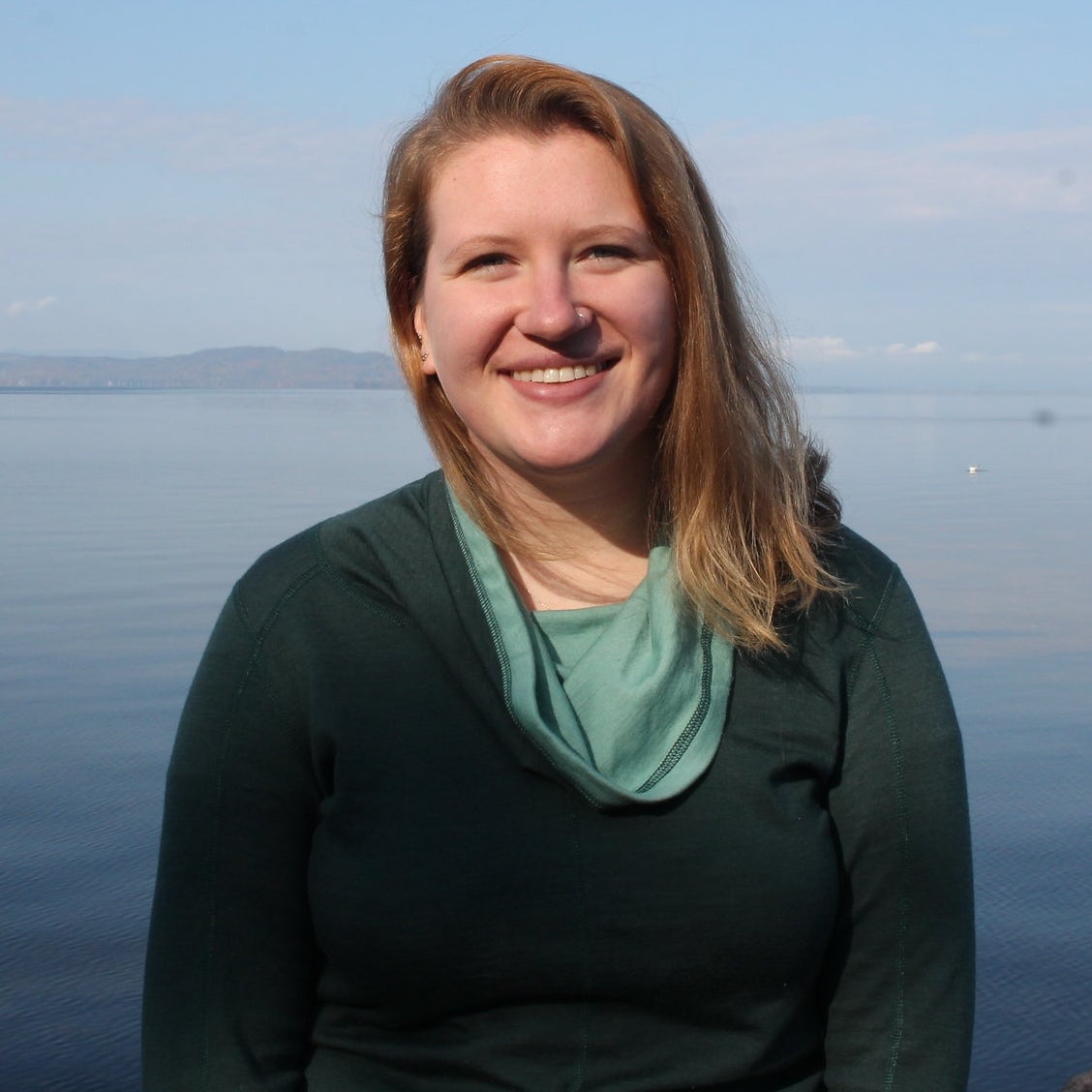 A profile photo of Emily Kaplita standing in front of Lake Champlain.