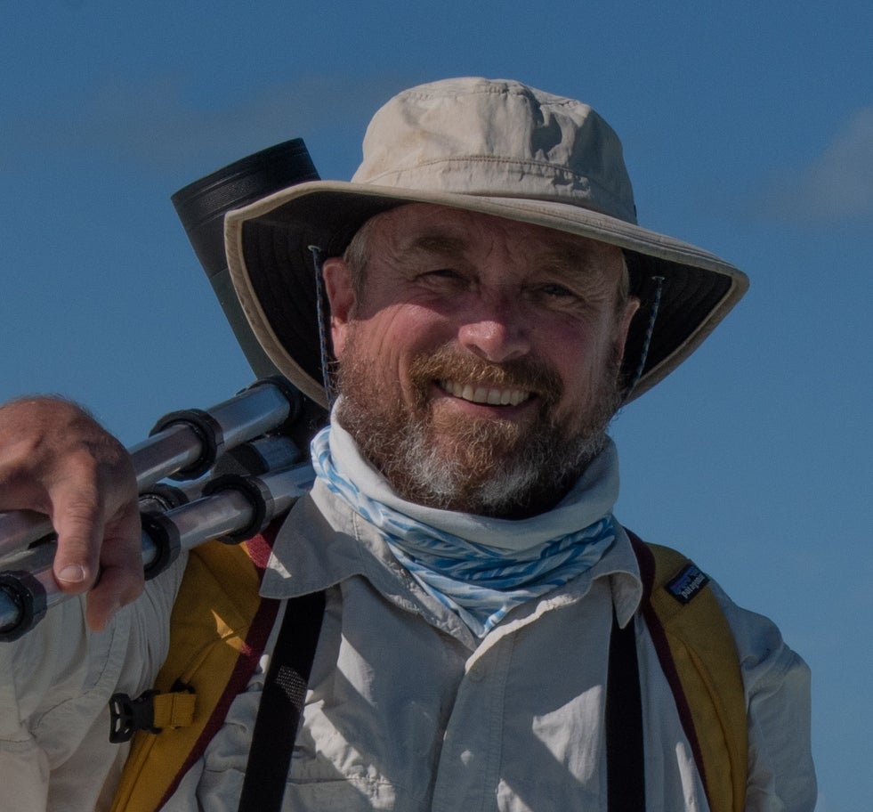 Mark LaBarr holds a scope over his shoulder.