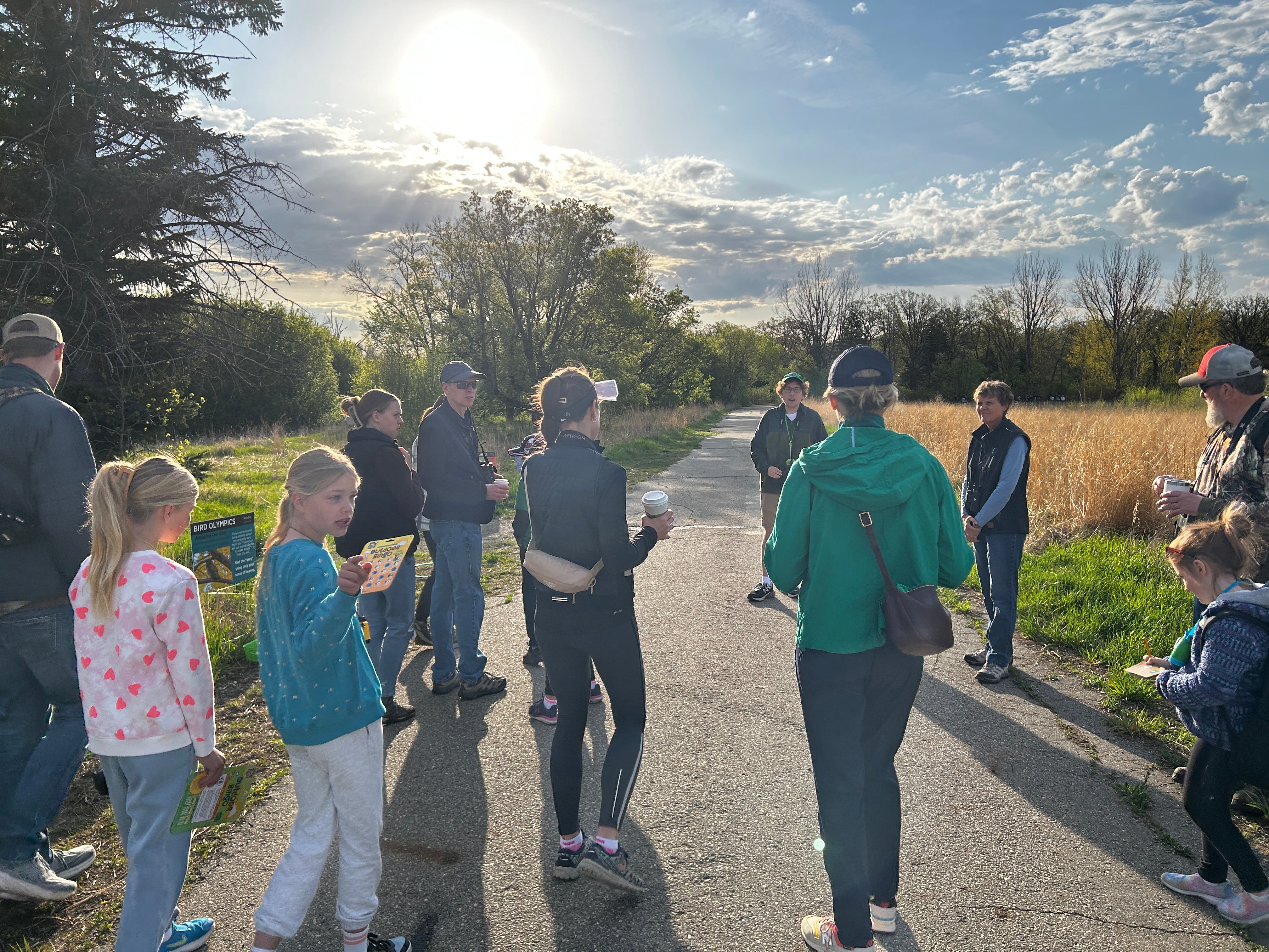 people outside on a sunny day, ready to go birding