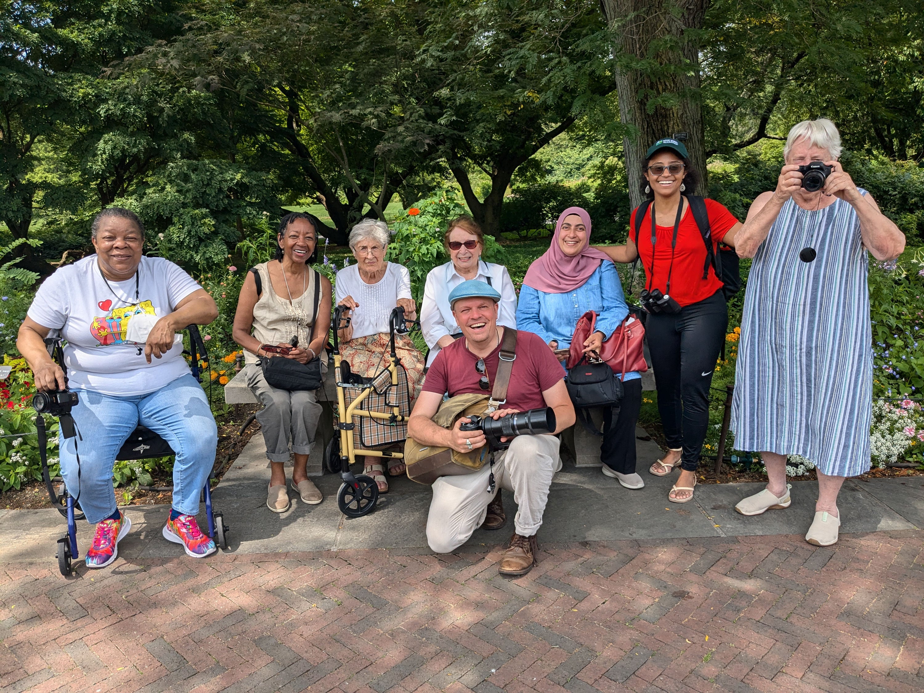 A group of people pose for a photo in a park.
