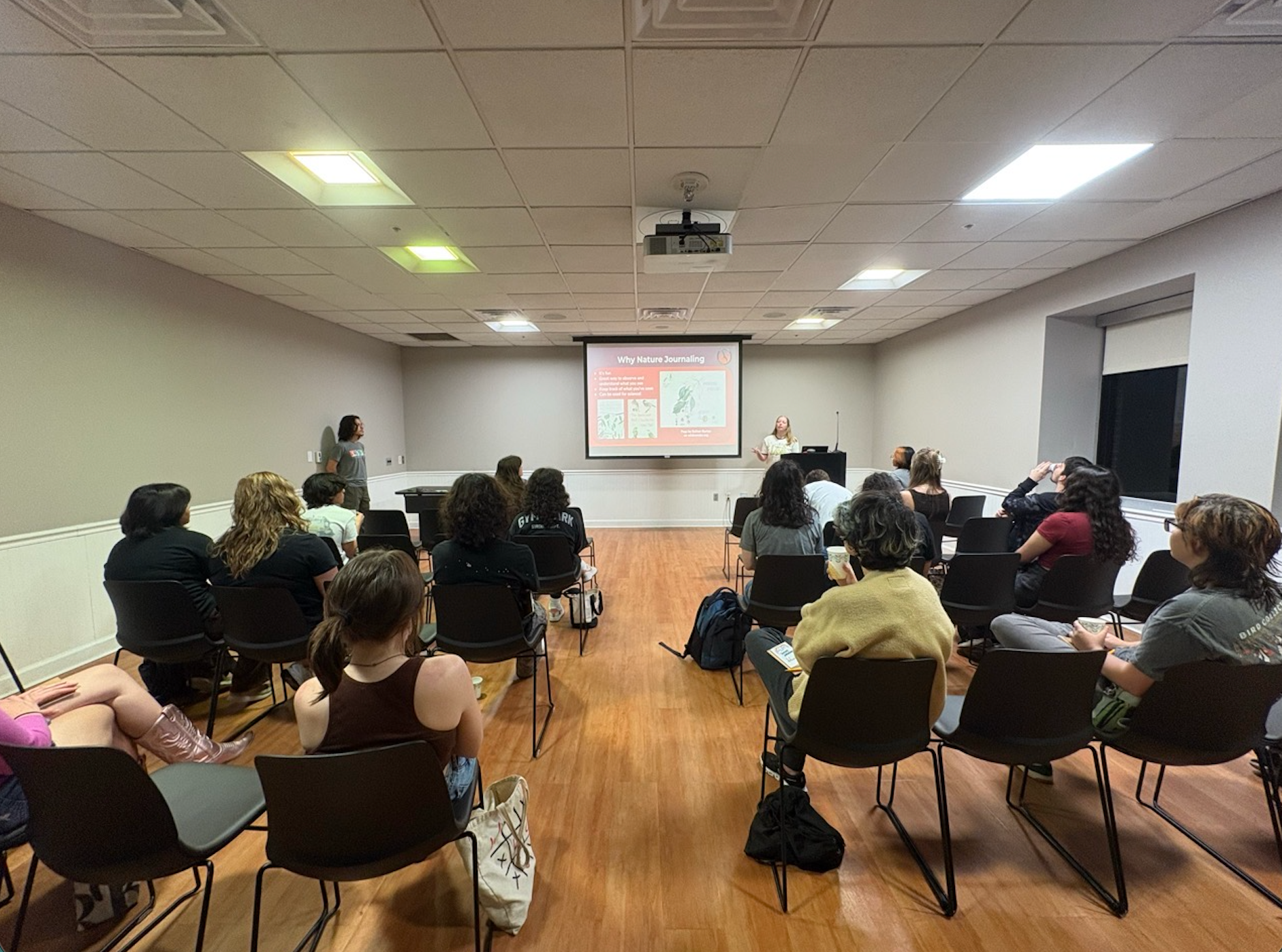 a group of students facing a screen