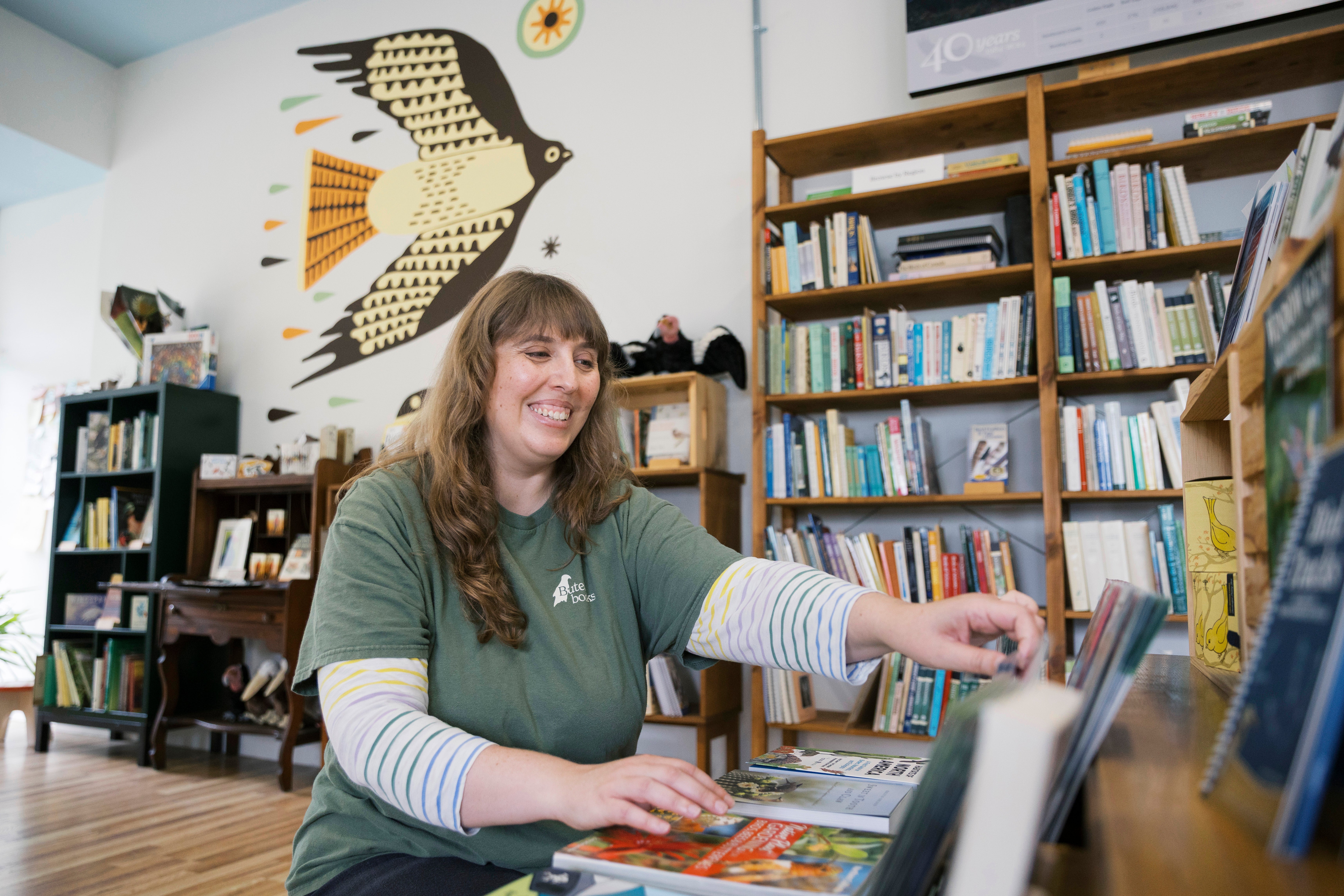 Lyzy Lusterman organizing books in her book store. 