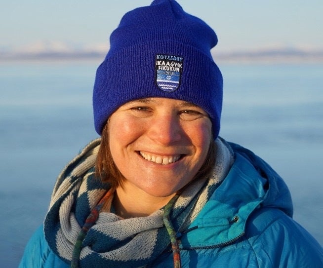 Woman smiling in jacket and hat