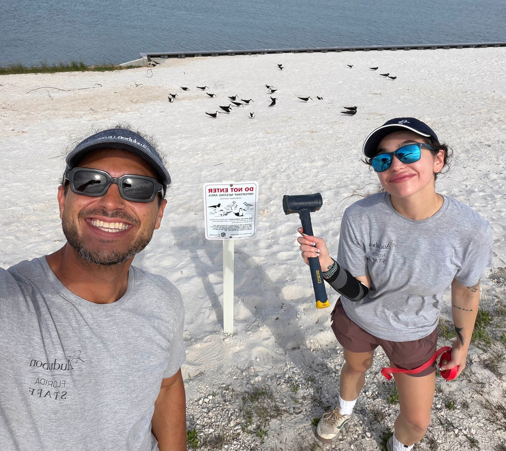 two people on the beach taking a selfie
