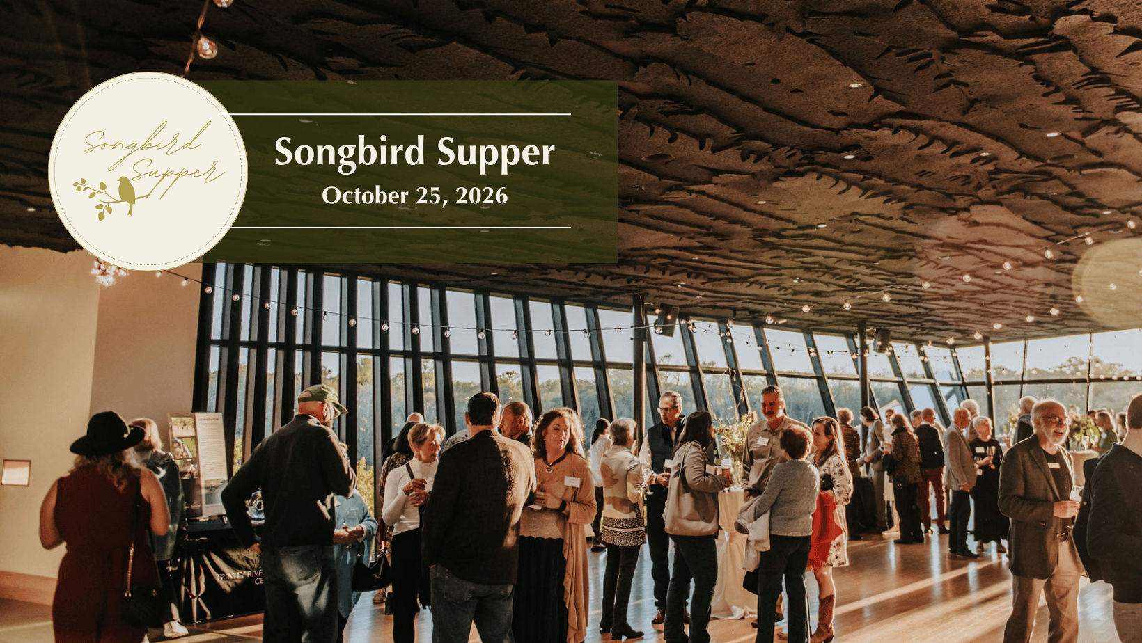 An ambient room of people at an event called Songbird Supper