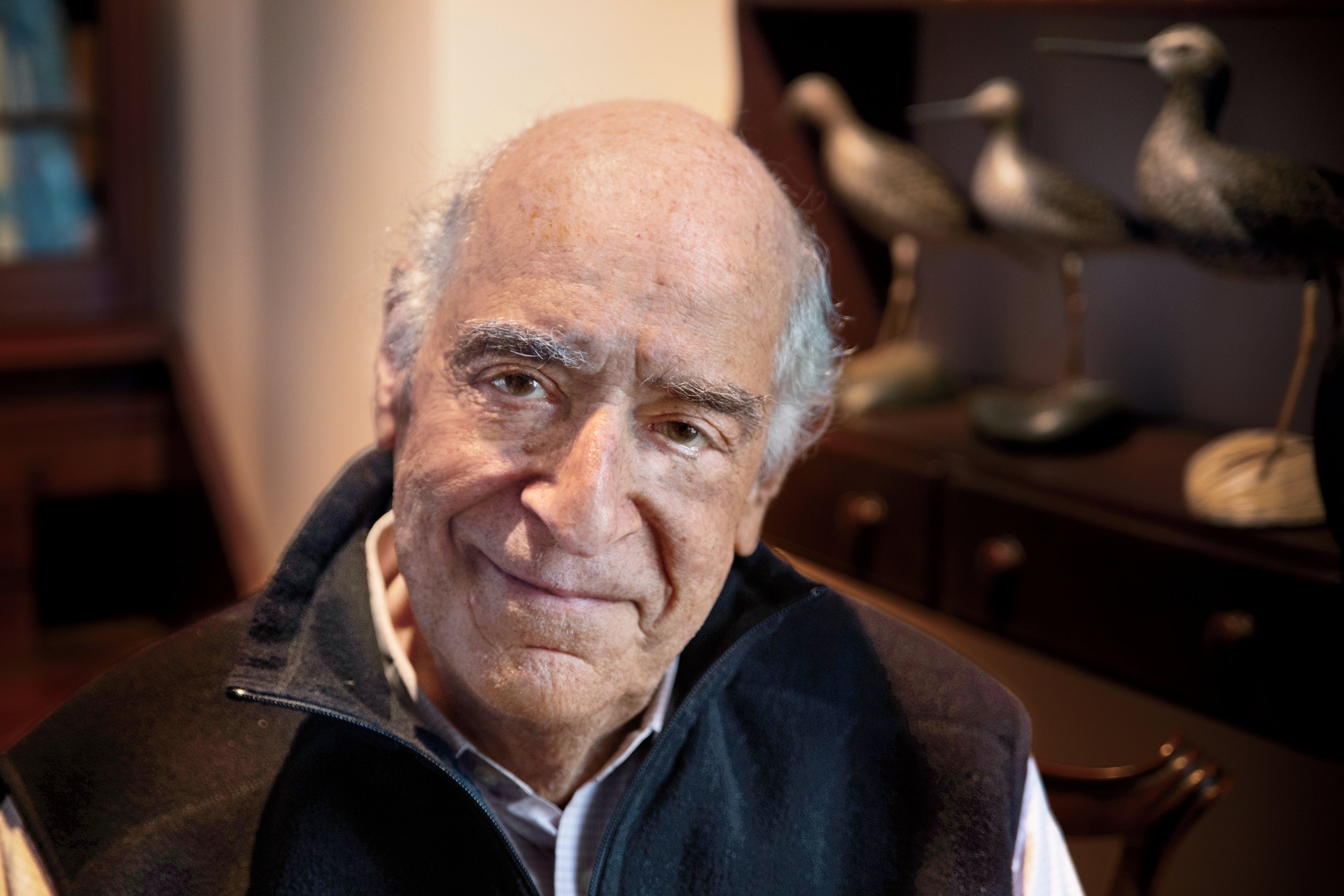 Portrait photo of a man looking at the camera. He is wearing a dark shirt.