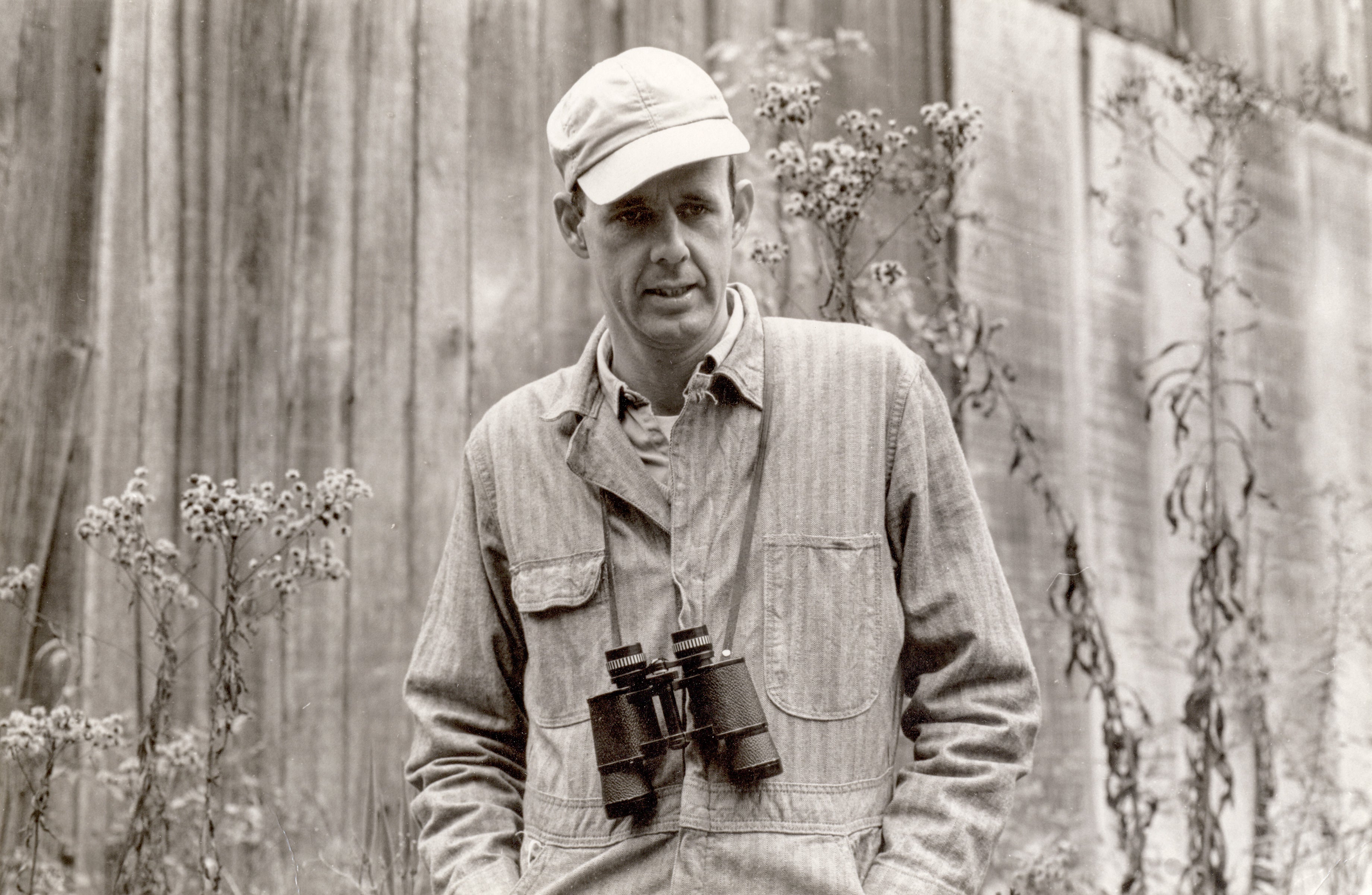 Black and white photo of young Wendell Berry wearing binoculars.