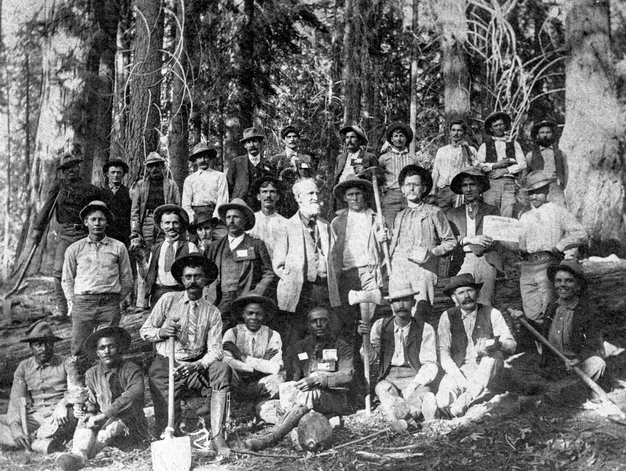 Young, bottom center, and road construction crew upon completion of road into Giant Forest in Sequoia National Park, 1903. National Park Service
