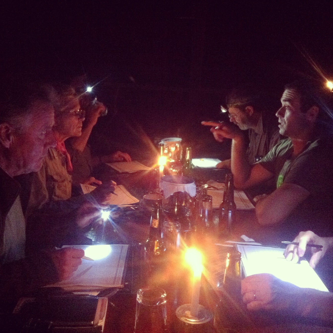 The group goes over the daily bird list by candlelight at the end of a long day at Shiripuno, Ecuador. Noah Strycker