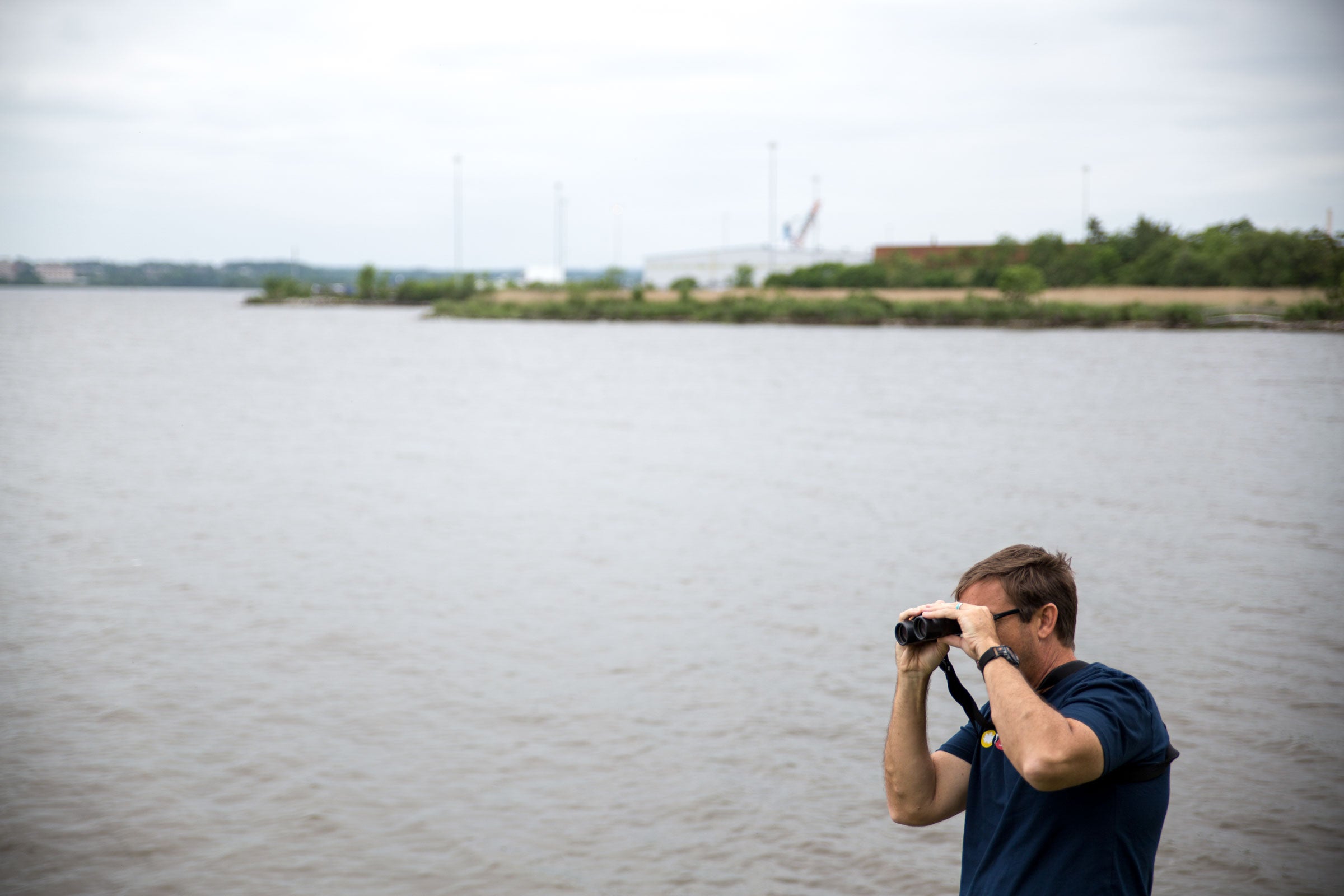 A festival goer scopes out a tiny Spotted Sandpiper along the harbor of Fort McHenry. More than 260 species have been recorded at the centuries-old monument and shrine. Camilla Cerea/Audubon