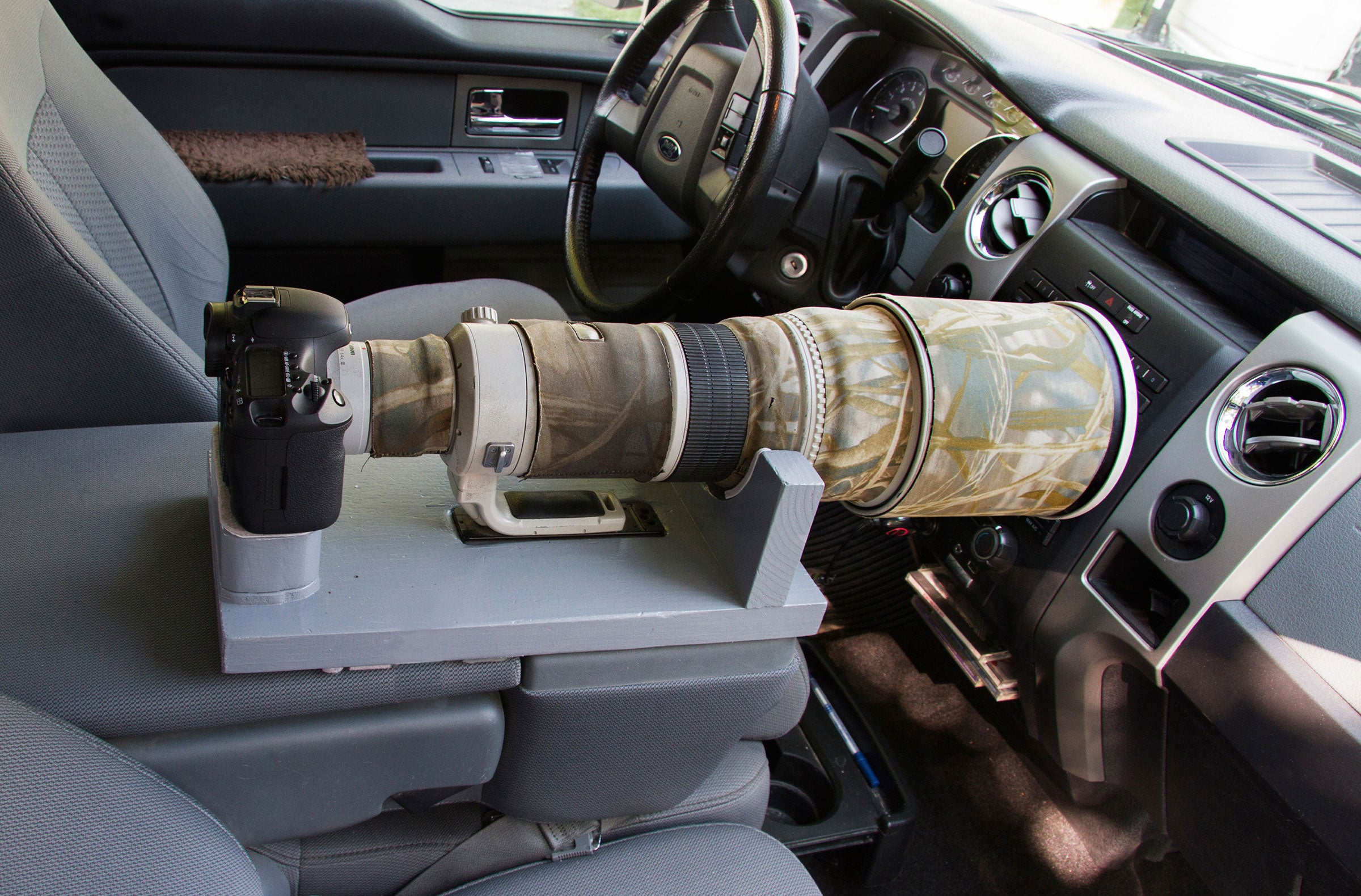 A DIY lens caddy for the center console keeps your setup secure while driving. Ron Dudley
