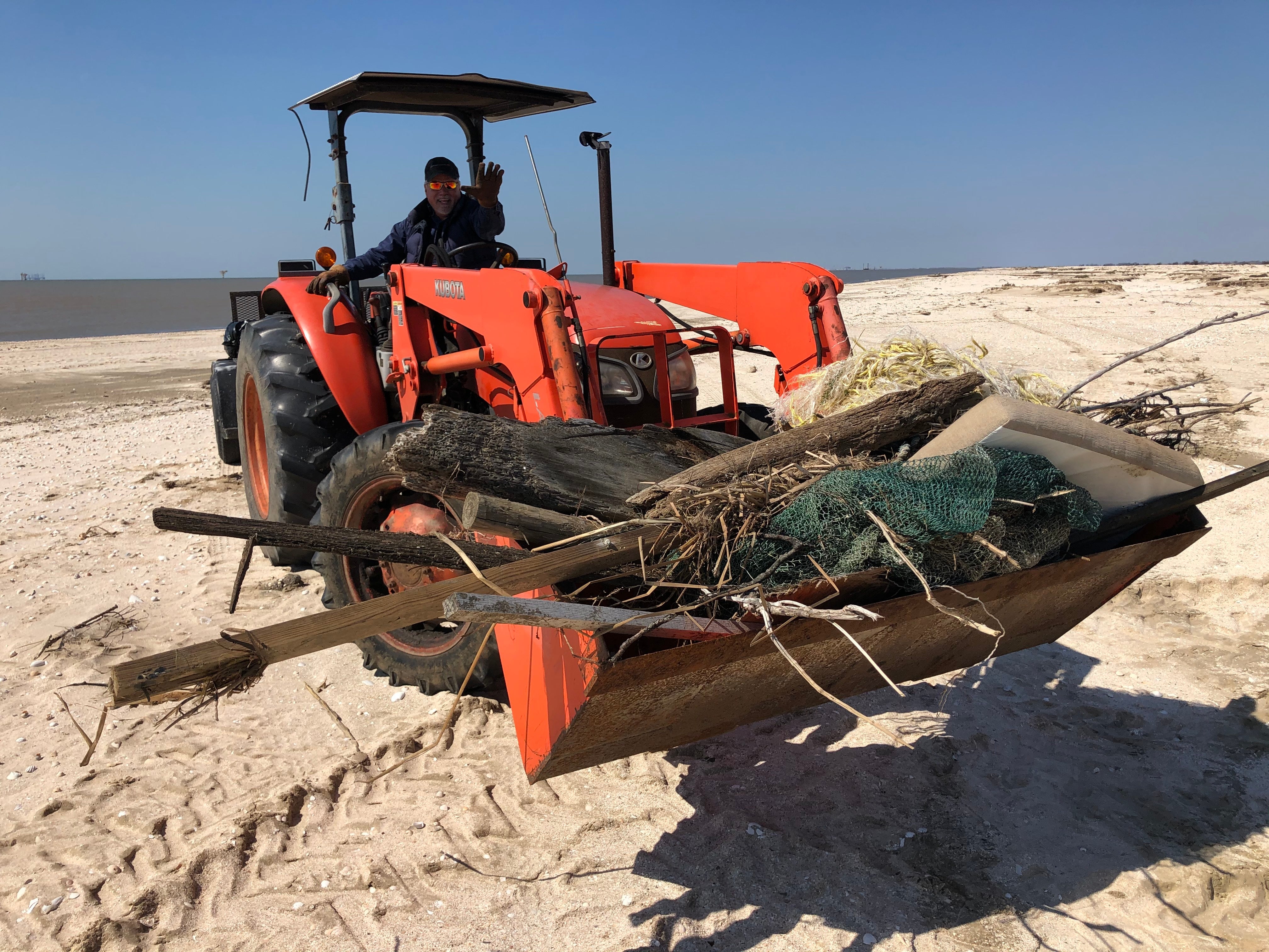 Cameron Parish President and Police Juror for District 5, Scott Trahan, removes large debris from Rutherford Beach with the help of his tractor. Katie Barnes/Audubon Louisiana