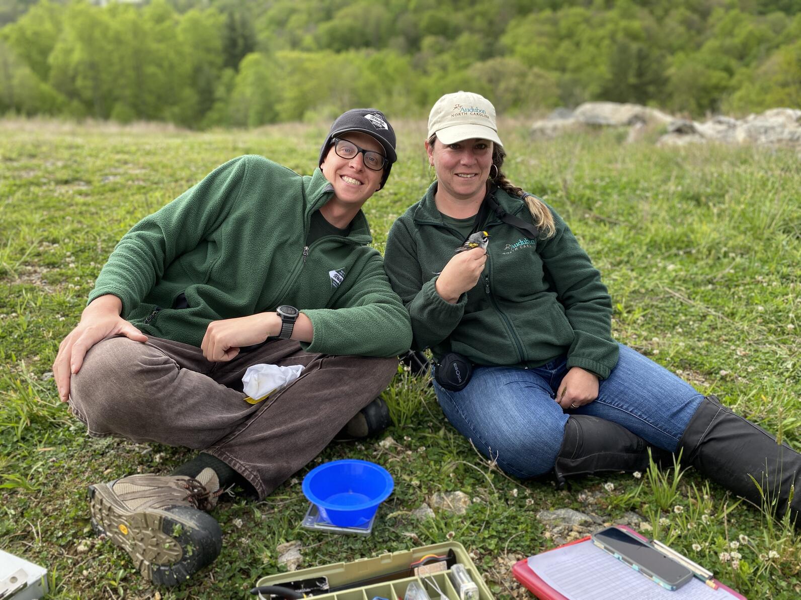 Researchers hold recently tagged Golden-winged Warblers.