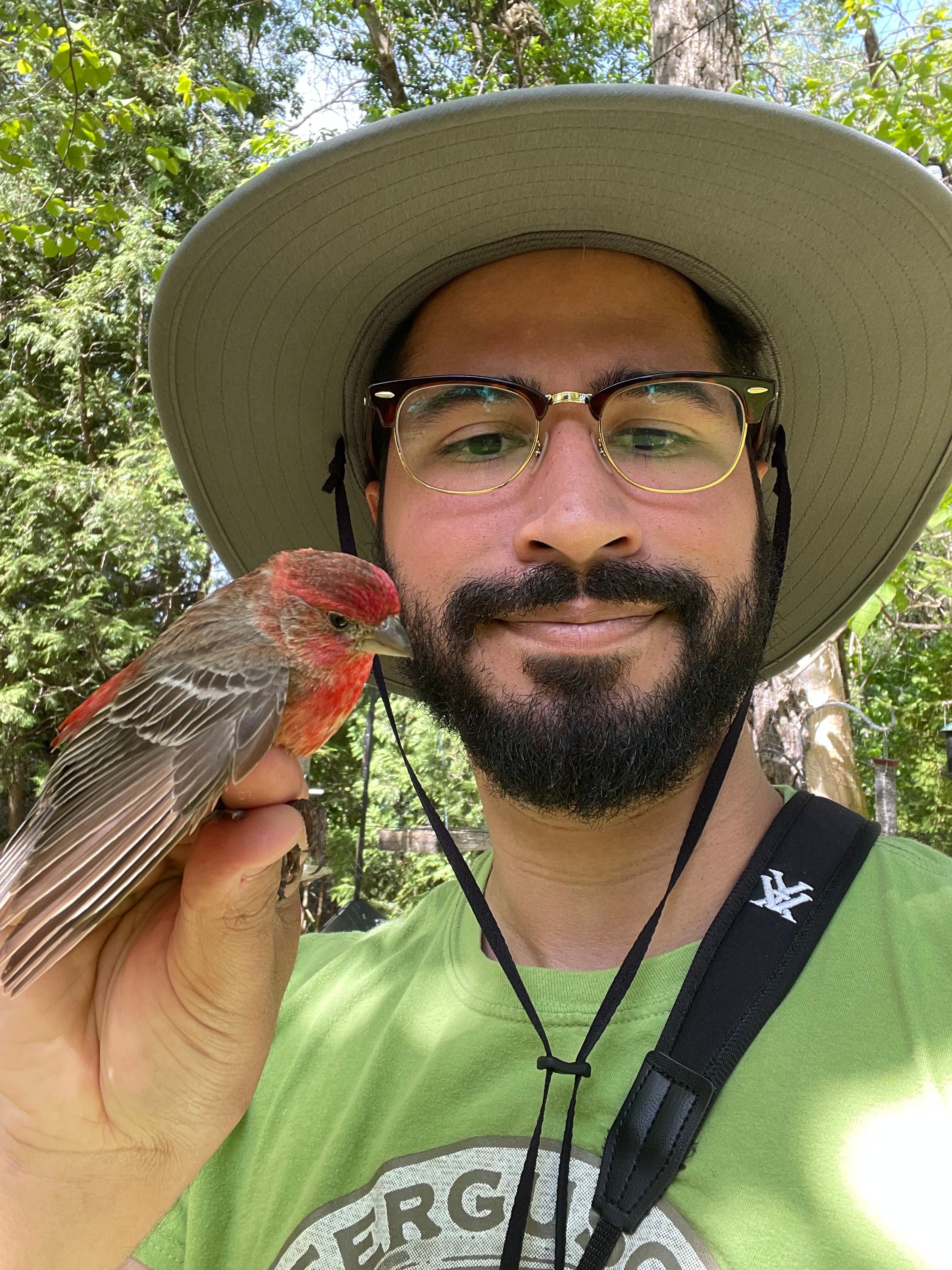 Sebastian Moreno holding a House Finch. 