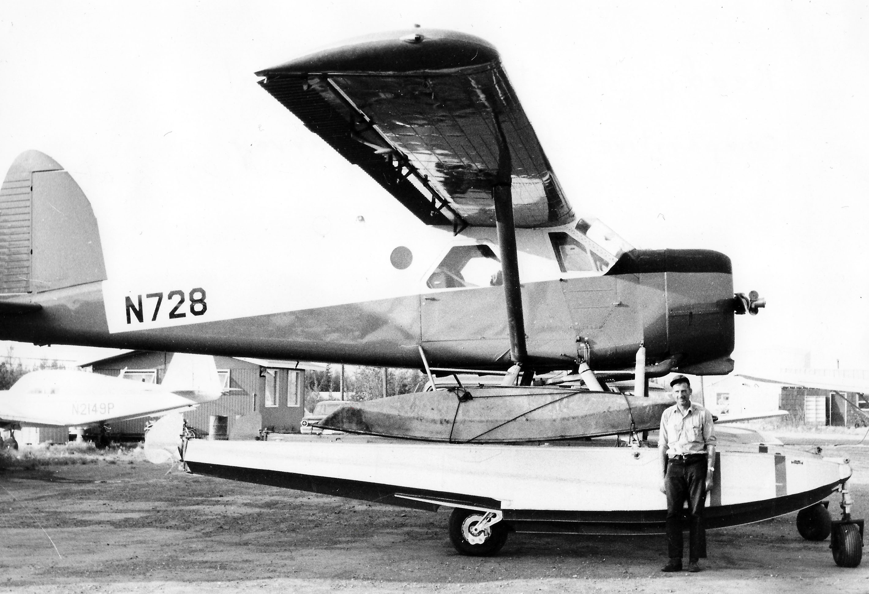 Man standing before small plane