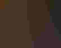 Three adults wearing solar glasses and watching the solar eclipse.