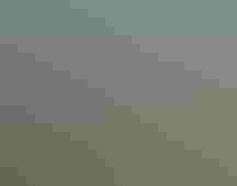 A smiling man in camouflage