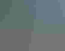 Four people, including Secretary Haaland, smile at the camera.