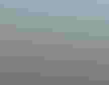 A lake behind a wire fence.