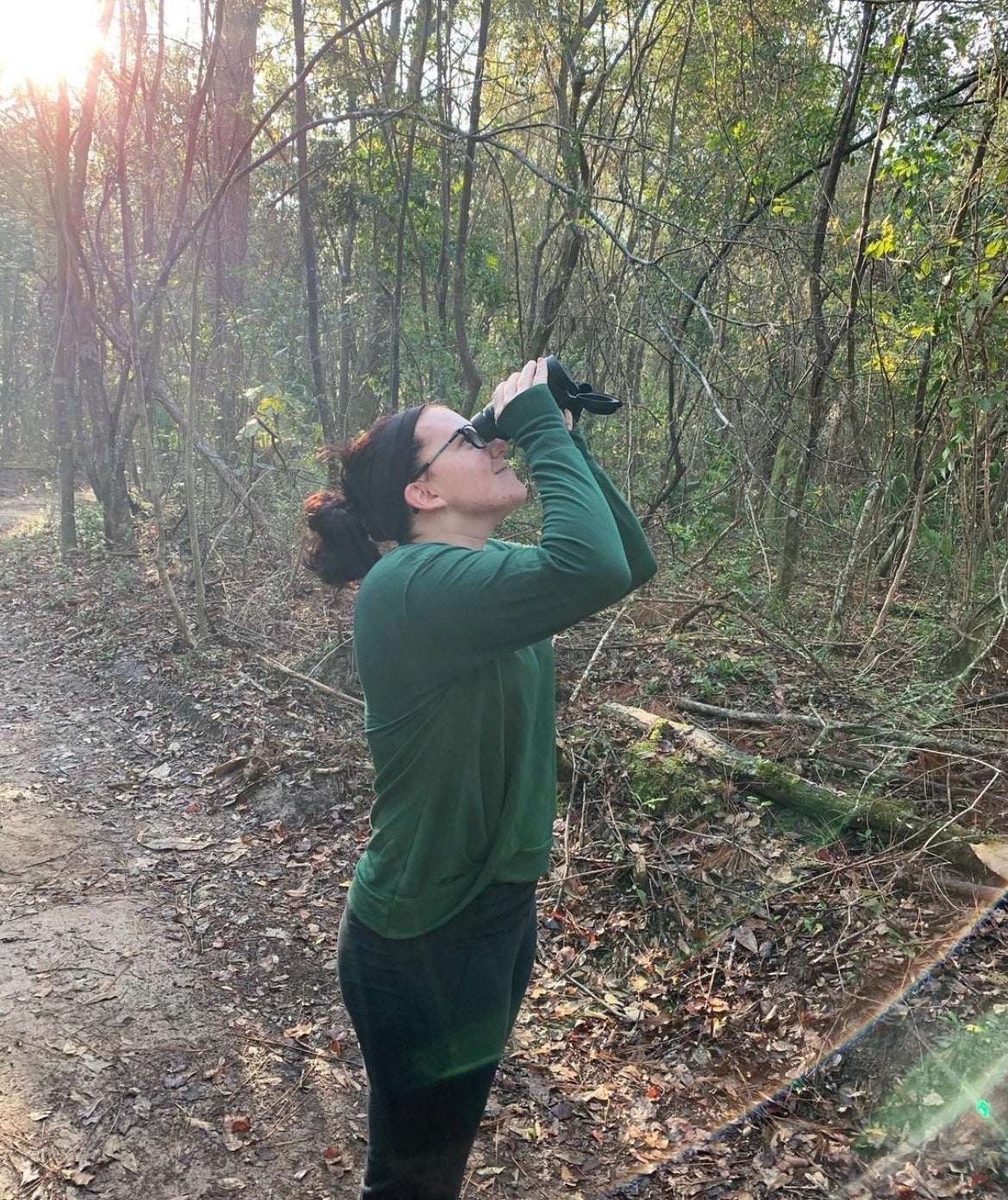 Amanda Hull peering at a Bald Eagle.