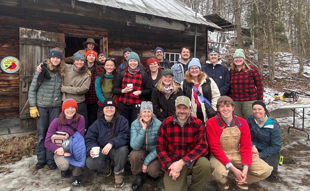 A group photo of ���Ĵ�ý staff and volunteers outside the sugarhouse.
