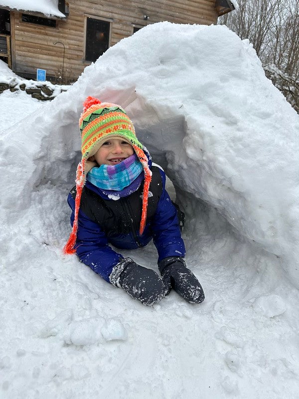 student in snow tunnel