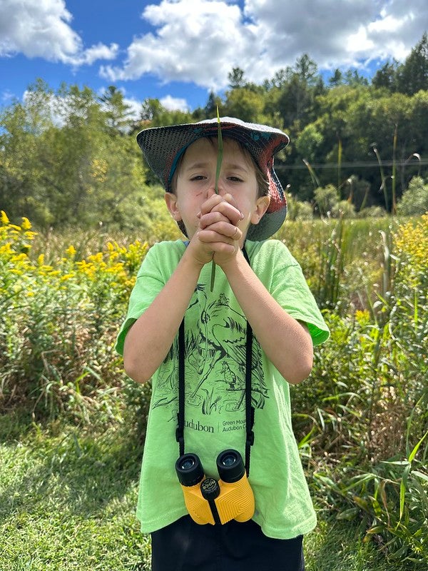 Student with grass whistle