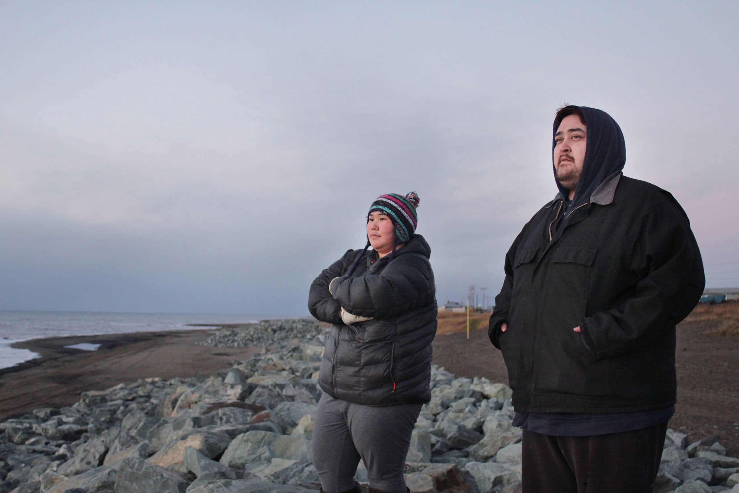 Elena Bodfish and James Griffin stand on a seawall built to protect the coastline. Madeline Ostrander