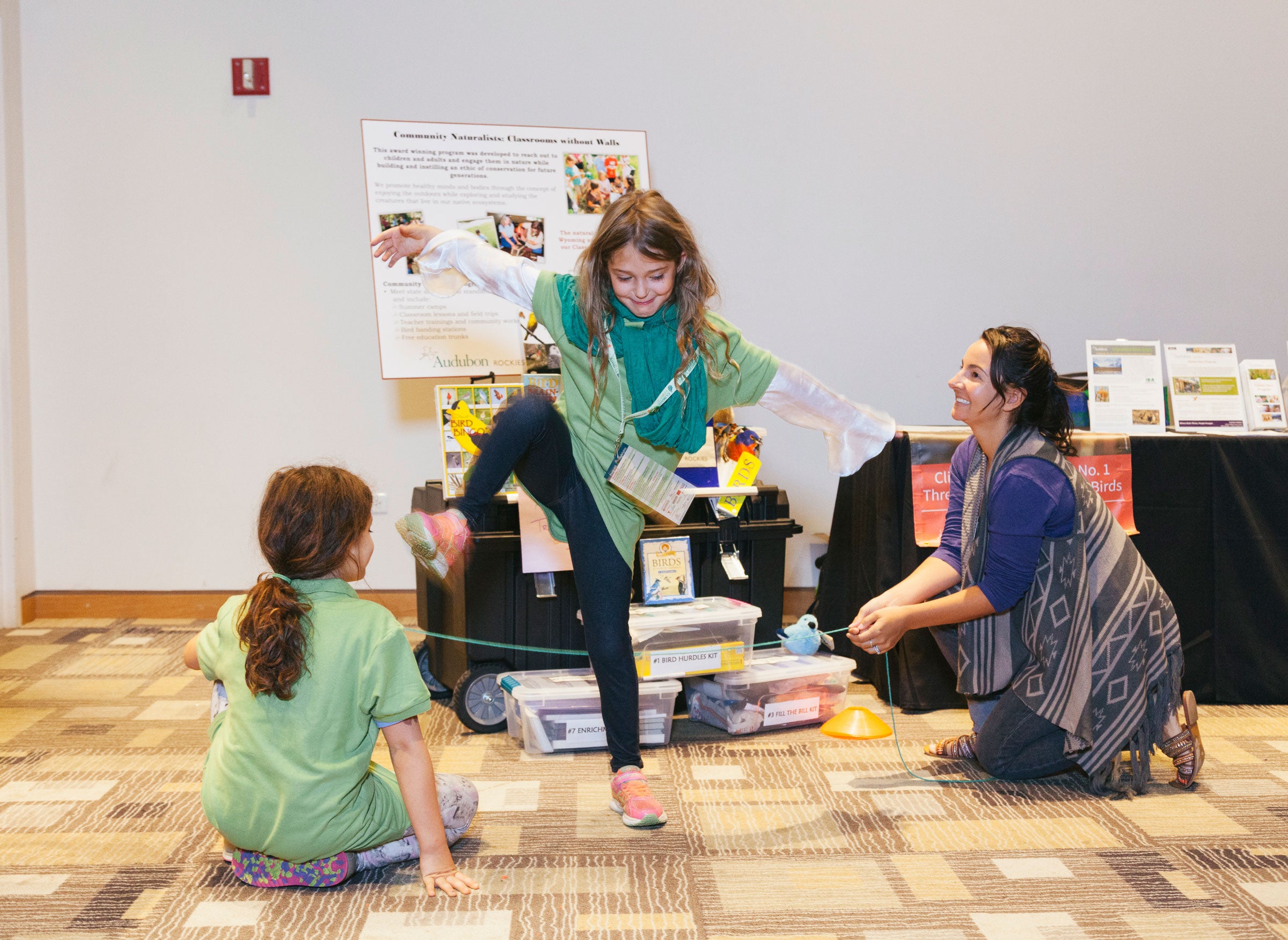 Two visitors participate in an activity from Audubon Rockies' "Bird Hurdle Kit," one of many learning games in the Birds and Climate Educational Traveling Trunk. Morgan Rachel Levy