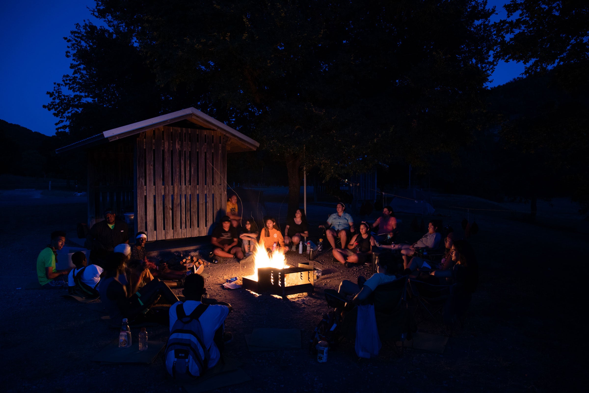 Campers and Audubon staff give compliments and share stories from the day around the fire as night falls. The camp may only run a week, but the community created is tight-knight and supportive. Luke Franke/Audubon