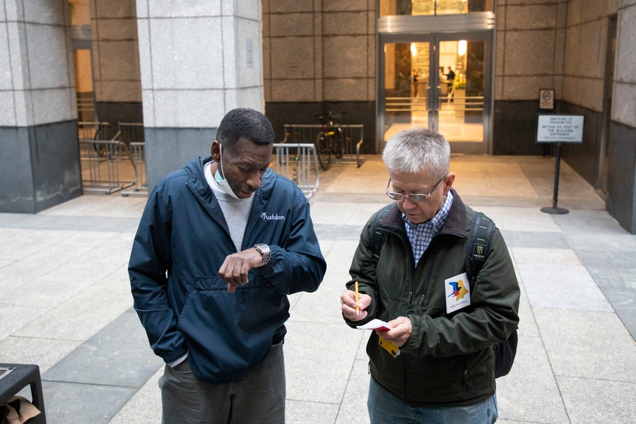 Keith Russell (left) and Stephen Maciejewski (right) look for injured or deceased birds in downtown Philadelphia on Oct. 21, 2021. Volunteers transport injured birds to a rehab facility. Photo: Luke Franke/Audubon