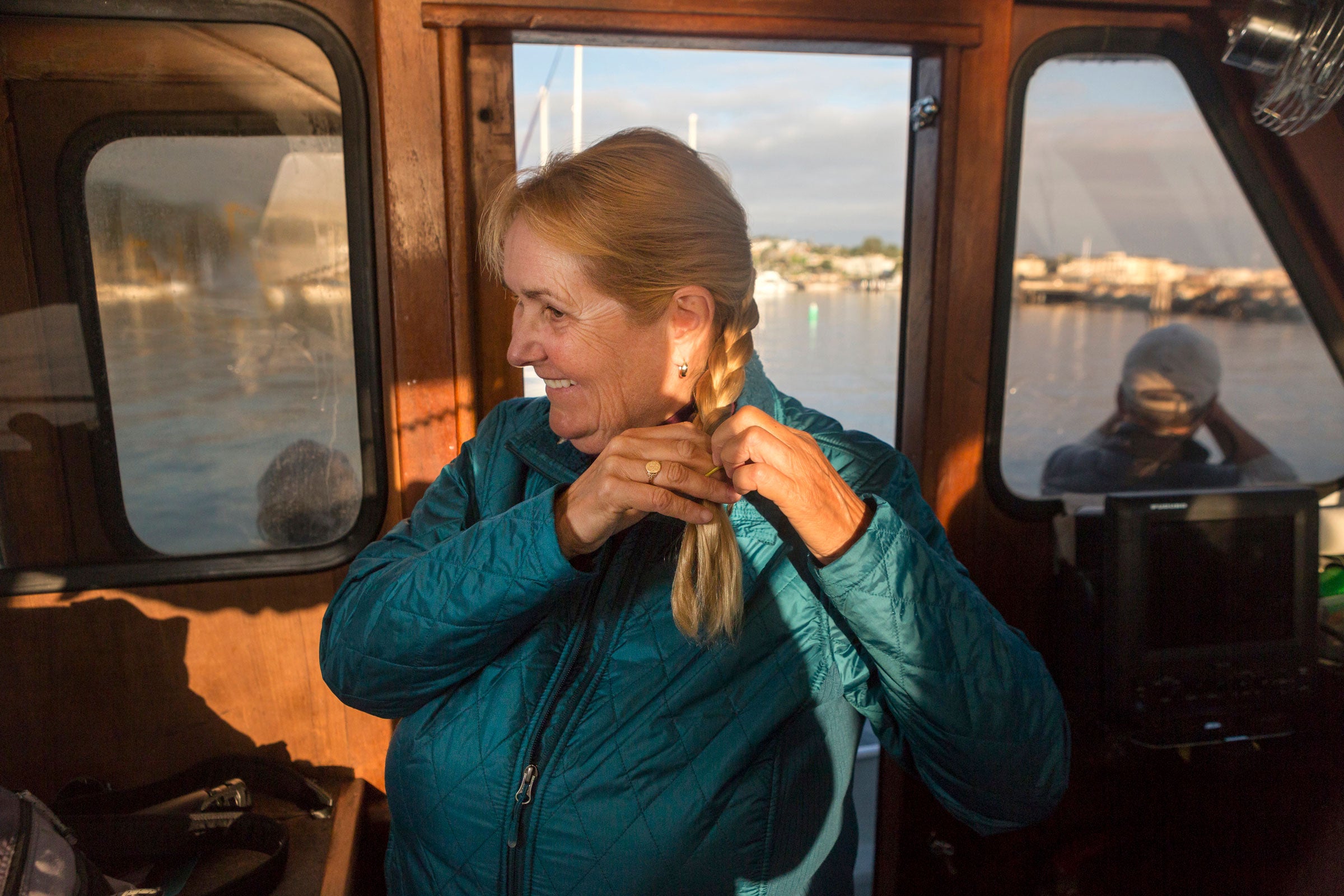 Shearwater braids her hair aboard Checkmate in preparation for one of her last tours with her company, Shearwater Journeys, in Monterey Bay. Lauren Owens Lambert