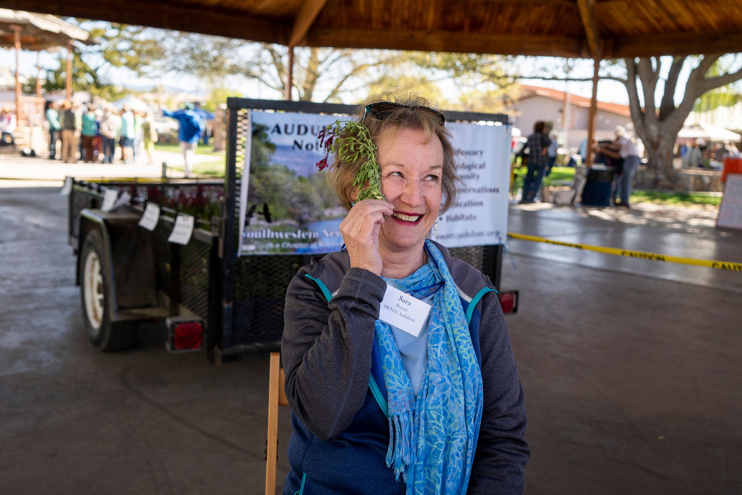 Sara Boyett, a volunteer for the Southwestern New Mexico Audubon Society, jokes around with a piece of autumn sage during the Plants for Birds Initiative event for Earth Day at Gough Park in Silver City, New Mexico on Saturday April 21, 2018. Paul Ratje