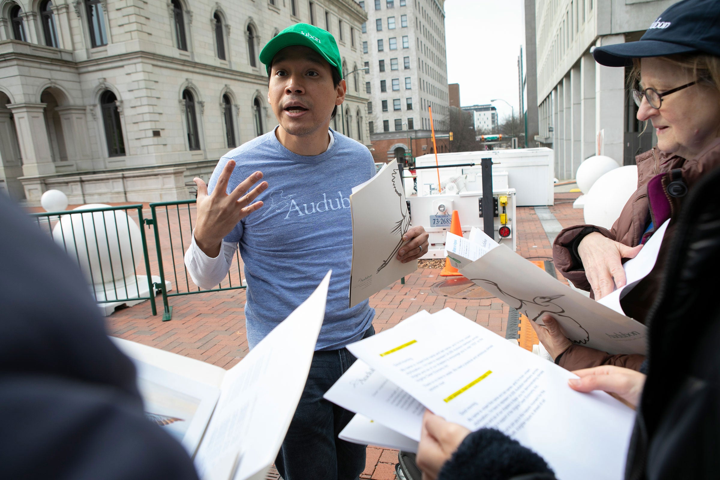 Volunteers and advocates gather at the Virginia State Capitol to celebrate the passage of the Virginia Clean Economy Act Friday, March 6, 2020 in Richmond, Virginia. Jaime Sigaran with the Audubon Society directs volunteers. Julia Rendleman